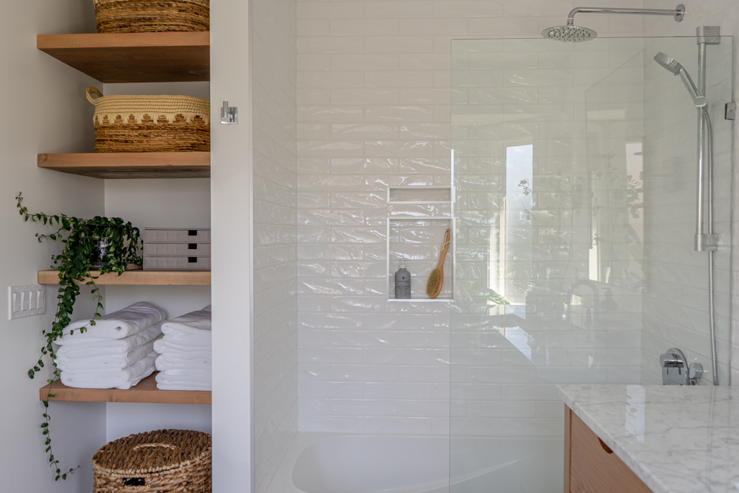 Modern bathroom with glass screen and open shelves